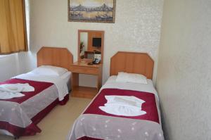 a hotel room with two beds and a mirror at Ekol Hotel in Istanbul +136 photos