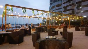 a patio with tables and chairs and lights at JOHOR BAHRU DANGABAY CIQ CITYSQUARE 2Bd 6PAX in Johor Bahru