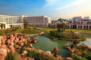 a view of a city with buildings and a pond at Sheraton Jiangyin Hotel in Jiangyin