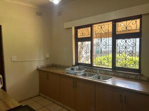 a kitchen with a sink and a window at 10 st Johns - House in Port Shepstone