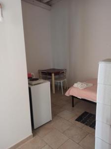 a small room with a table and a refrigerator at Cara Casa al Porto n.25 in Bari