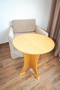 a wooden coffee table in a living room with a couch at Hotel Aurora in Saints Constantine and Helena