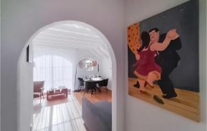 a painting of a couple dancing in a living room at 2 Bedroom Amazing Home In Putten in Putten