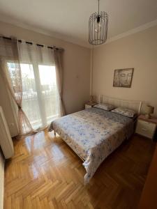 1 dormitorio con cama y lámpara de araña en luxury apartment center athens (wifi), en Atenas