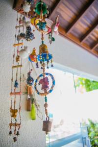 a bunch ofadedadedadedaded items hanging from a wall at Lorenza by Paramar in Ubatuba
