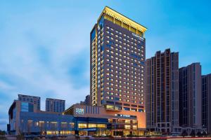 a tall building with lights on top of it at Four Points By Sheraton Guilin Lingui in Guilin