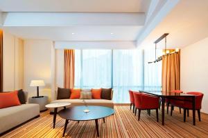 a living room with a couch and a table at Four Points By Sheraton Guilin Lingui in Guilin