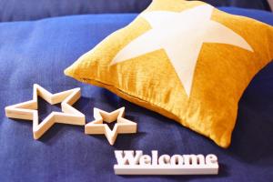 a bed with a pillow and two stars on it at カモミール西町201 in Kume
