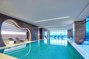 a pool in a hotel with a view of the ocean at Four Points By Sheraton Guilin Lingui in Guilin