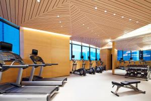 a gym with a row of treadmills and ellipticals at Four Points By Sheraton Guilin Lingui in Guilin