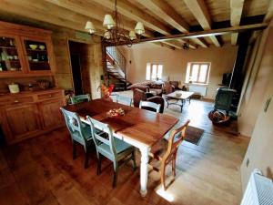 a dining room and living room with a wooden table and chairs at La Grange in Fter