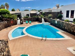 una piscina nel mezzo di un patio di Oasis en Lanzarote a Costa Teguise