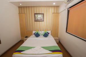 a small bedroom with a bed in a room at Hotel Serene Viman Nagar in Pune