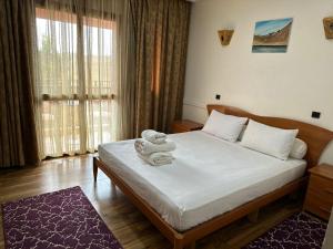 a bedroom with a bed with a teddy bear on it at Amrouss touristic DarMaroc in Azrou +43 photos