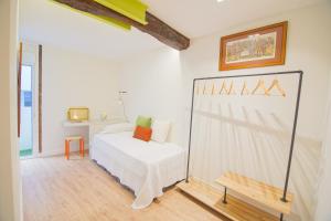 een witte slaapkamer met een bed en een bureau bij Ardigales Casco Antiguo in Castro-Urdiales