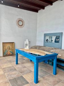 a blue table in a room with a couch at Bel Air surf escape in El Cotillo