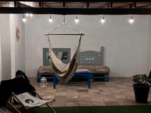 a hammock hanging in a room with two beds at Bel Air surf escape in El Cotillo