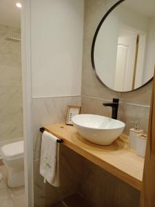 a bathroom with a white sink and a mirror at Bóreas Ecoluxury Glamping in El Calafate