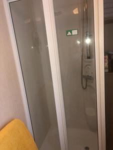 a shower with a glass door in a bathroom at Blue quary in Hastings