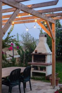 a patio with a pizza oven under a wooden pergola at Masal Evimiz in Antalya