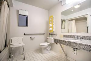 a bathroom with a toilet and a sink and a mirror at Motel 6-Bozeman, MT in Bozeman