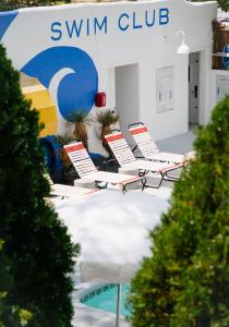 a group of chairs sitting in front of a swim club at El Rey Court in Santa Fe