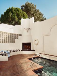 a swimming pool with a fireplace in front of a building at El Rey Court in Santa Fe