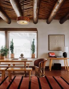 a living room with a table and chairs and a window at El Rey Court in Santa Fe