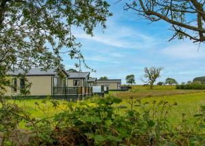 a house in the middle of a field at Heathergate Boutique Holiday Park in Hexham