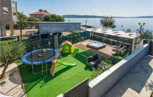a backyard with a playground and a play structure at Lovely Apartment In Kastel Kambelovac With Jacuzzi in Kaštela