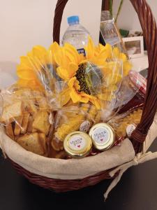 a basket with yellow flowers and bottles of water at Moinho das fragas in Figueiró dos Vinhos