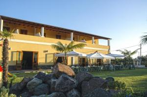 a building with a bunch of rocks in front of it at Eolian Residence in Lipari