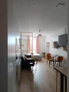 a living room with a couch and a table at Résidence Les Bénédictins in Limoges