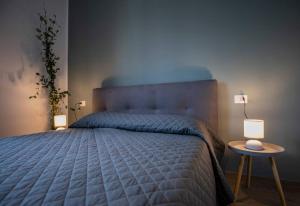 a bedroom with a large bed with two lamps at Luxury House Belgrande in Milan