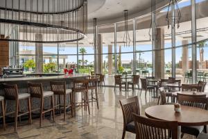 a restaurant with tables and chairs and a bar at Pickalbatros Golf Luxury Suites - All Inclusive in Sharm El Sheikh