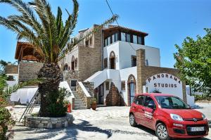 a red car parked in front of a building at Panorama Studios in Kefalos