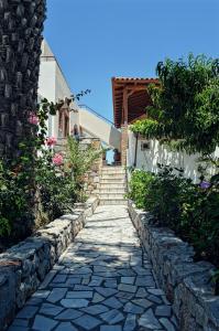 a stone path in front of a house with stairs at Panorama Studios in Kefalos
