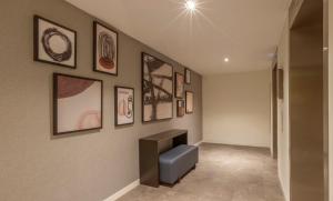 a living room with a wall with pictures on it at The Gibson Hotel in Dublin