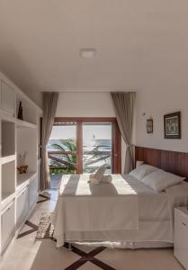 a bedroom with a bed and a large window at Casa Canoa Camocim in Camocim +100 photos