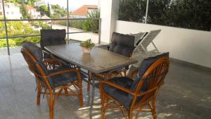 a table and chairs sitting on a patio at Apartments Aba in Hvar