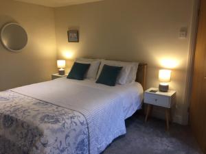 a bedroom with a large bed with two night stands at Rock View in Froggatt
