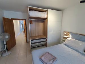 1 dormitorio con cama y armario abierto en Spinola Bayview Apartment, en San Julián
