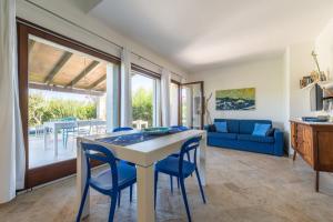 a kitchen and living room with a table and chairs at Villa Bouganville Cala Sinzias in Castiadas