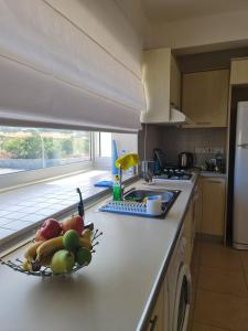 a kitchen with a bowl of fruit on a counter at Penthouse with rooftop terrace in Akanthou +9 photos