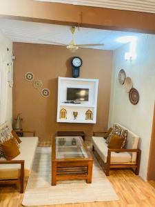 a living room with two couches and a coffee table at SAFARI in Stone Town