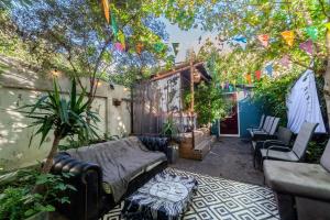 a patio with a couch and chairs in a yard at Master En - Suite Townhouse double with Garden & Hot Tub in London