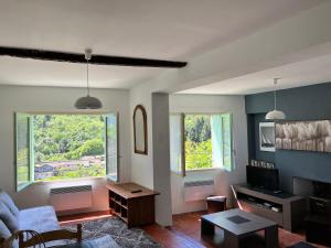 sala de estar con sofá y mesa en La Roseraie - Gite avec piscine en Cévennes, en Roquedur