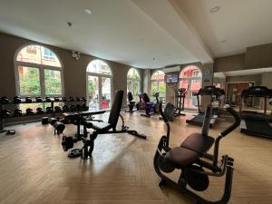 a gym with treadmills and exercise bikes in a room at Seven Seas Condo Pattaya - 7 seas pool view in Jomtien Beach