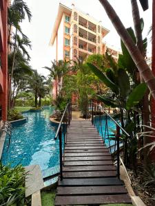 a staircase leading to a swimming pool in a resort at Seven Seas Condo Pattaya - 7 seas pool view in Jomtien Beach