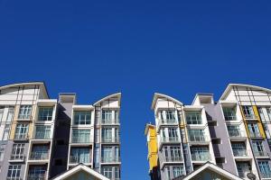 a tall apartment building with a blue sky in the background at G Residence - 2BR Family Suite Barrington Night Market - 4 in Brinchang